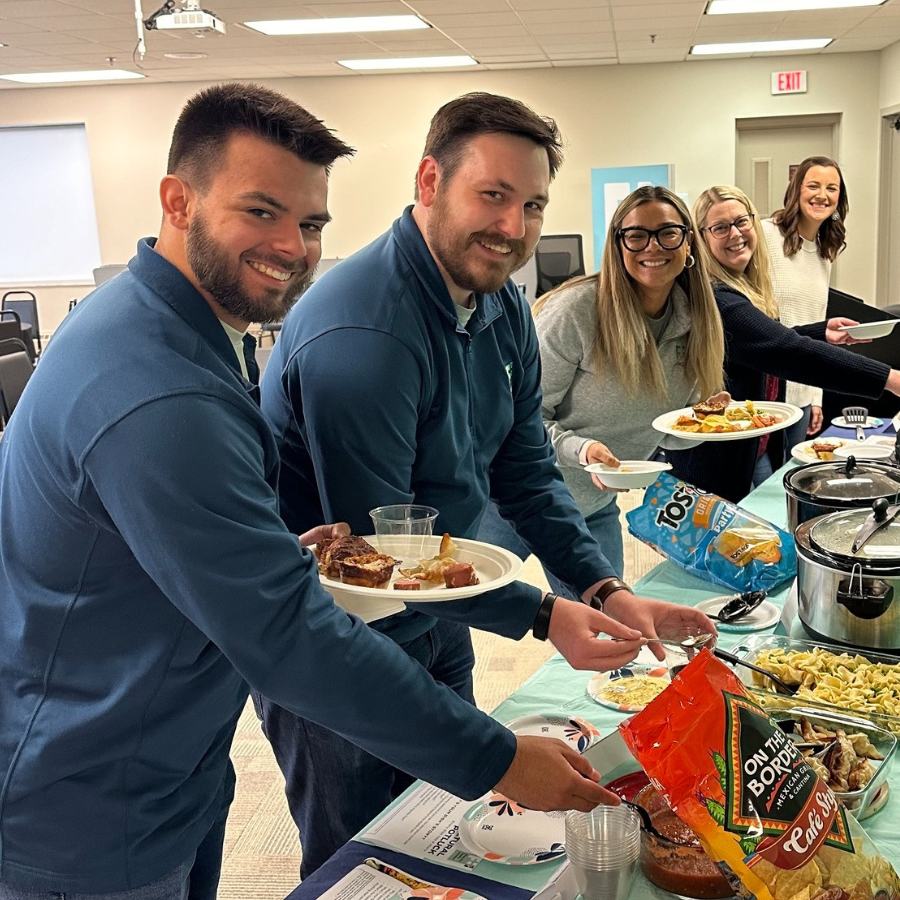 Financial Plus employees grabbing food at the Multicultural Potluck.