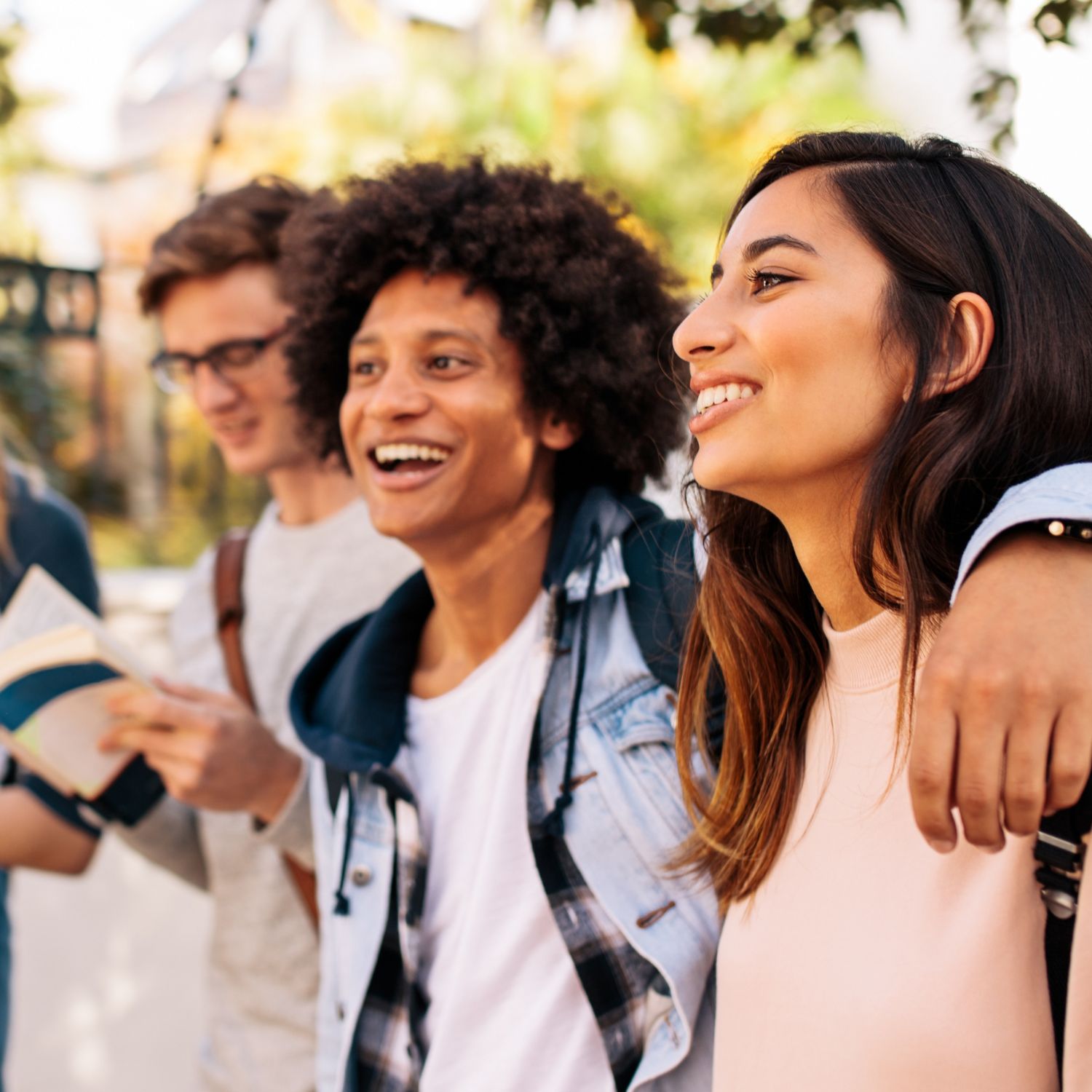 group of college students arm in arm on college campus